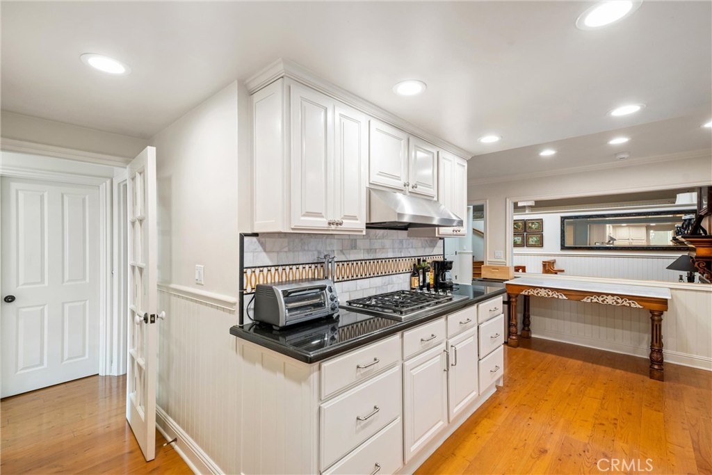 1008 West Oceanfront Newport Beach, CA 92661 - Photo 21 of 59 a kitchen with stainless steel appliances granite countertop a stove and a sink