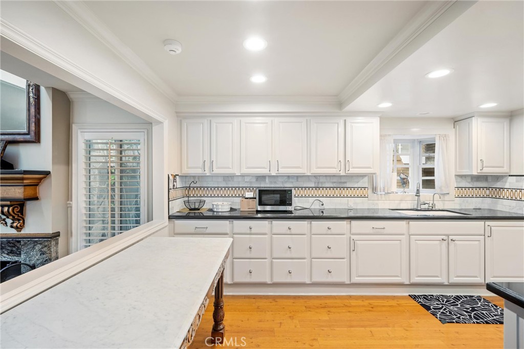 1008 West Oceanfront Newport Beach, CA 92661 - Photo 23 of 59 a large kitchen with granite countertop a stove a sink and a granite counter tops
