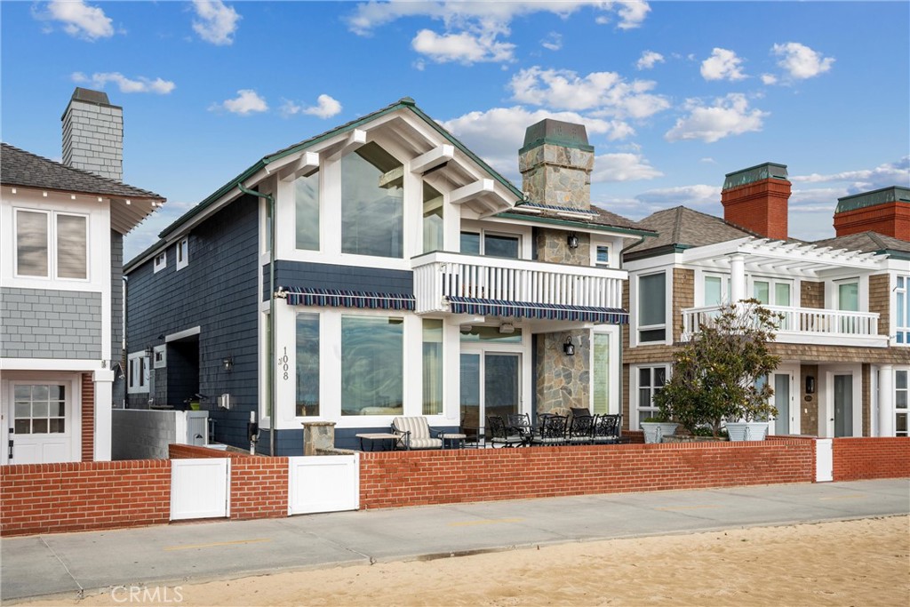 1008 West Oceanfront Newport Beach, CA 92661 - Photo 3 of 59 a front view of a house with a yard