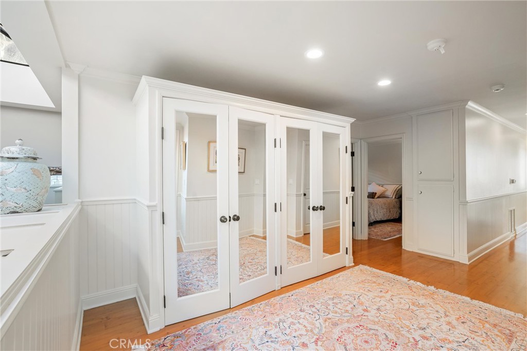 1008 West Oceanfront Newport Beach, CA 92661 - Photo 34 of 59 a view of a hallway with wooden floor and a bathroom