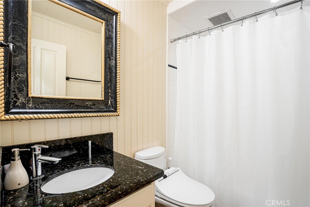 1008 West Oceanfront Newport Beach, CA 92661 - Photo 37 of 59 a bathroom with a sink toilet and mirror
