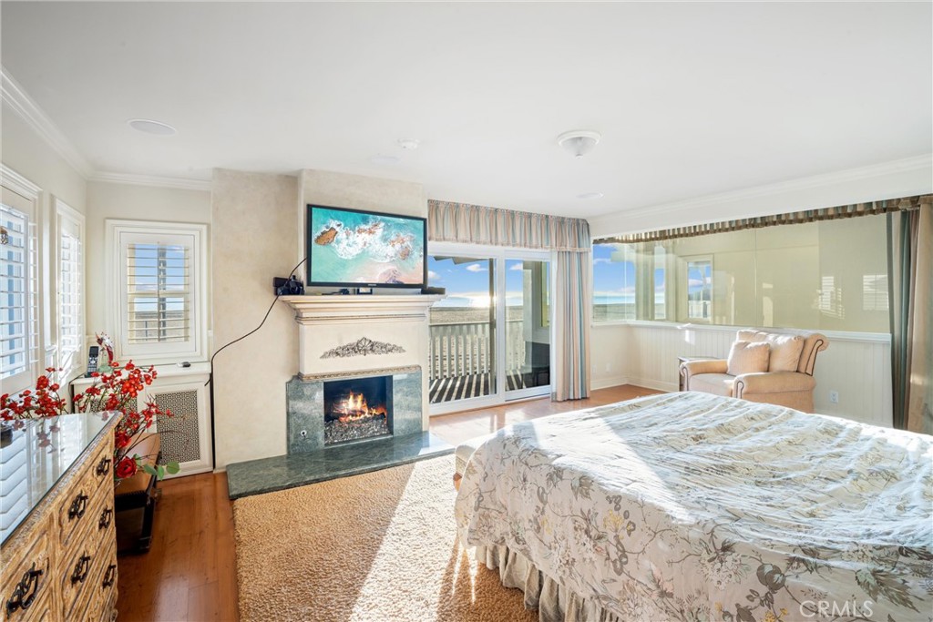 1008 West Oceanfront Newport Beach, CA 92661 - Photo 39 of 59 a bedroom with a bed and a fireplace