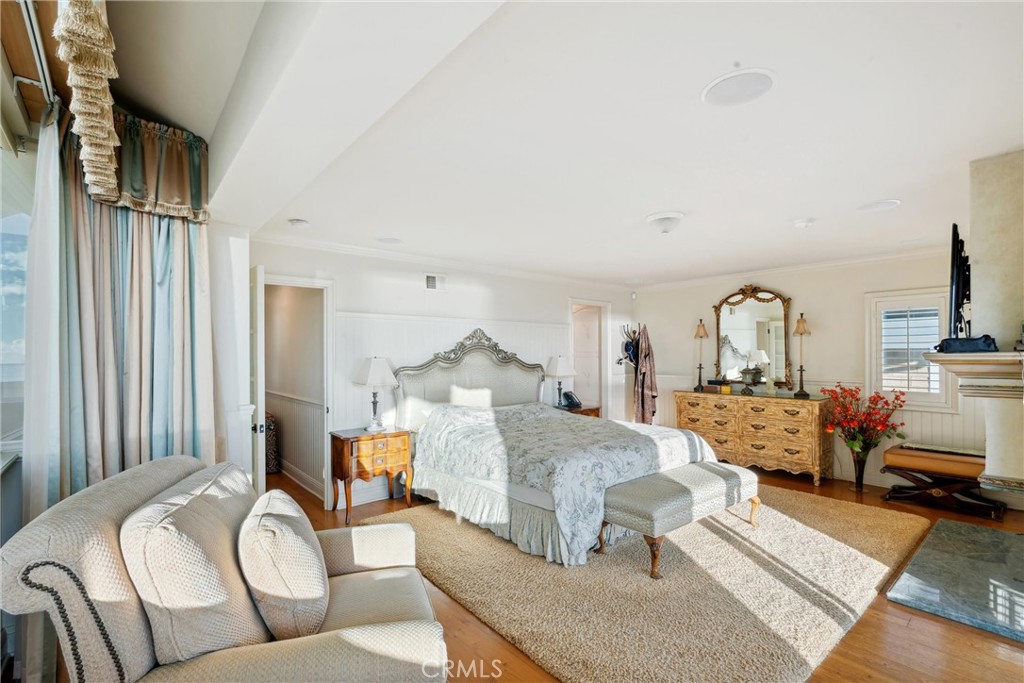 1008 West Oceanfront Newport Beach, CA 92661 - Photo 40 of 59 a bedroom with furniture and a fireplace