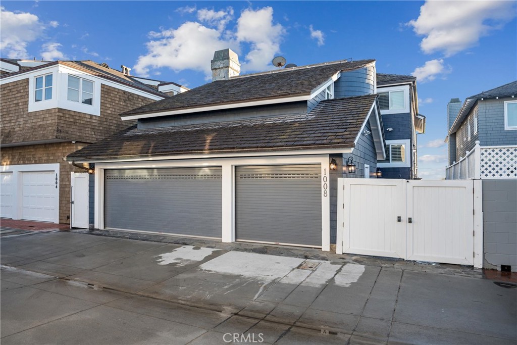 1008 West Oceanfront Newport Beach, CA 92661 - Photo 49 of 59 a front view of a house with garage
