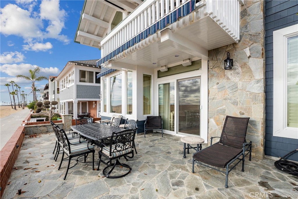 1008 West Oceanfront Newport Beach, CA 92661 - Photo 8 of 59 a view of a patio with couches table and chairs and potted plants