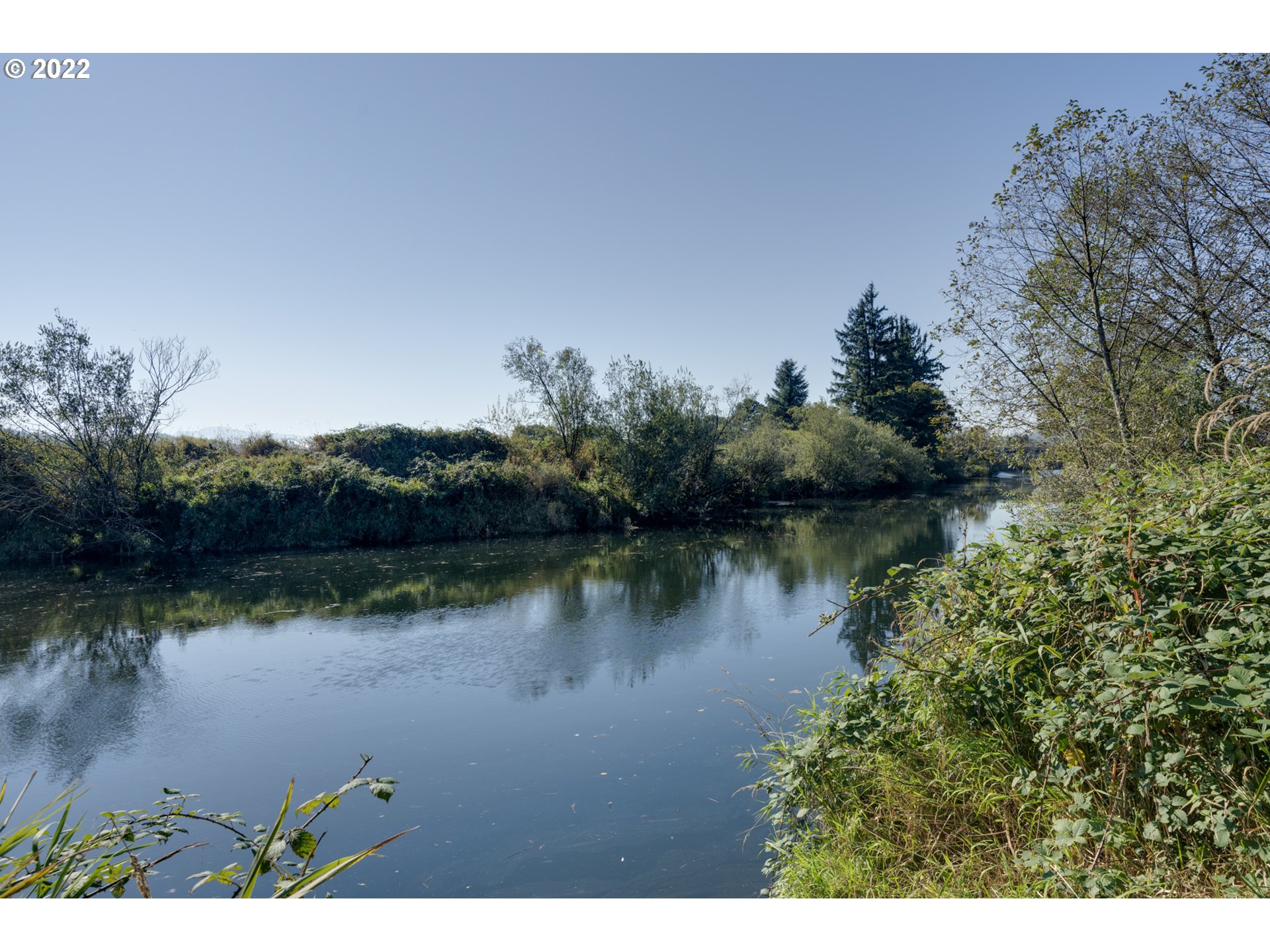 2110 Nielsen Road Tillamook, OR 97141 - Photo 4 of 26 a view of a lake with houses in the back