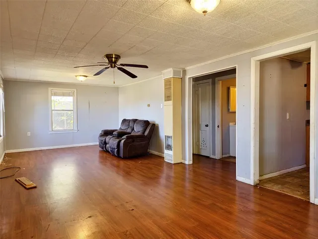 a living room with furniture and a ceiling fan