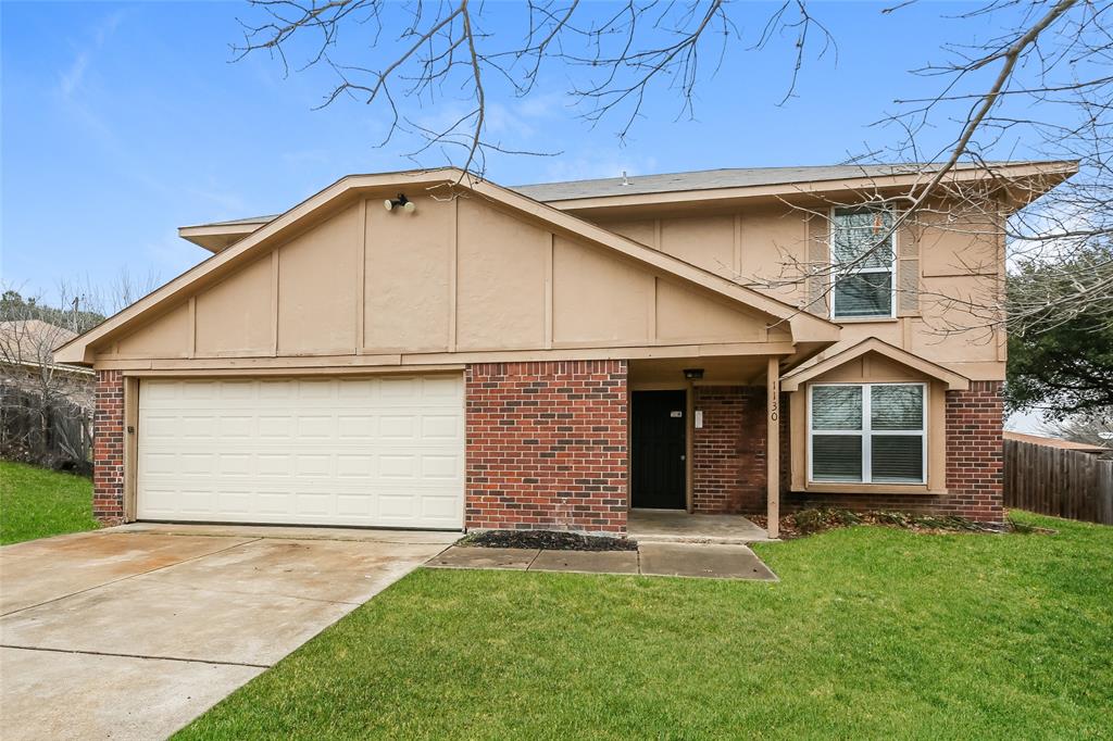 a front view of a house with a garden and yard