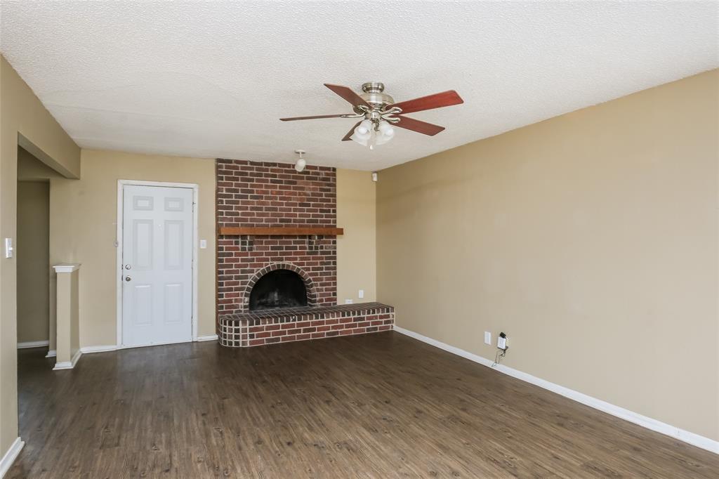 1130 Judy Avenue Benbrook, TX 76126 - Photo 2 of 17 a view of a livingroom with wooden floor a ceiling fan and a window