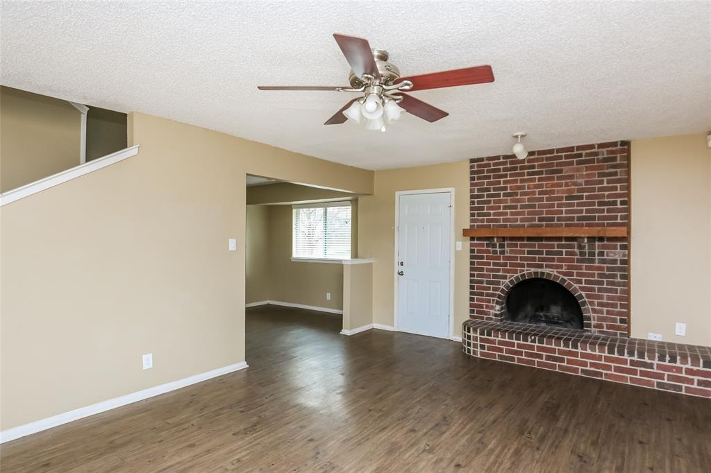 1130 Judy Avenue Benbrook, TX 76126 - Photo 3 of 17 a view of an empty room with wooden floor fireplace and a window