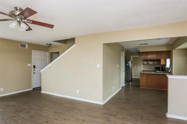 a view of a kitchen with a sink cabinets and wooden floor