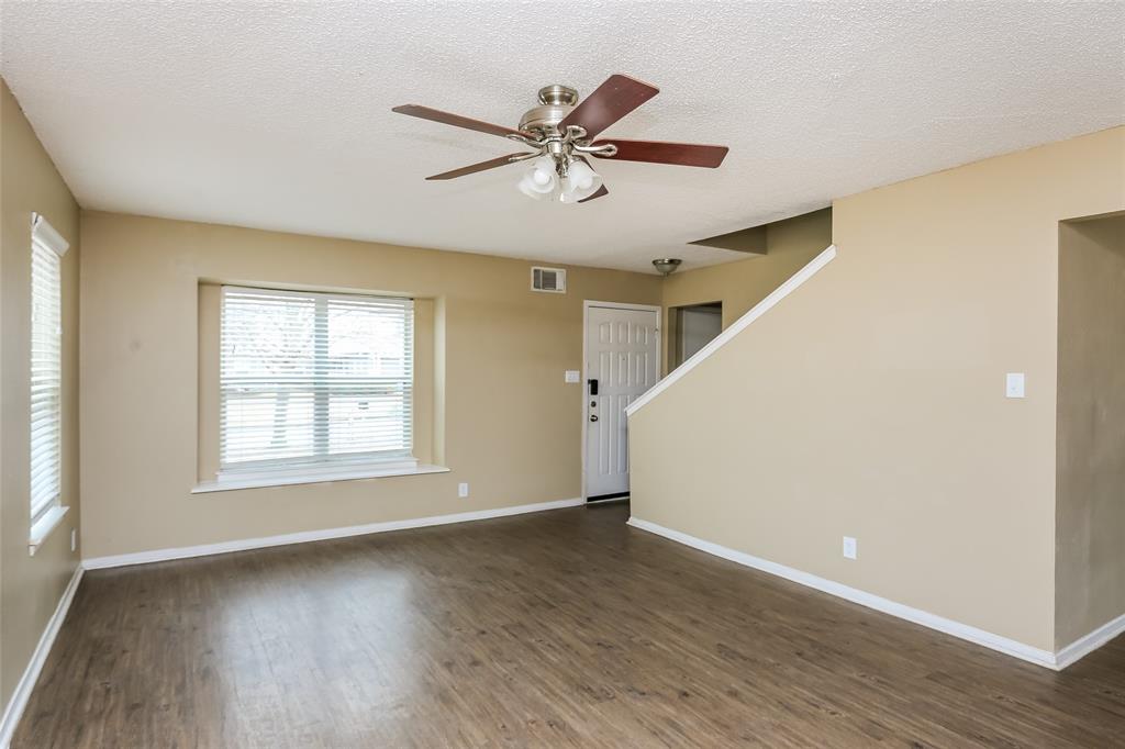 1130 Judy Avenue Benbrook, TX 76126 - Photo 5 of 17 a view of a livingroom with wooden floor and a ceiling fan
