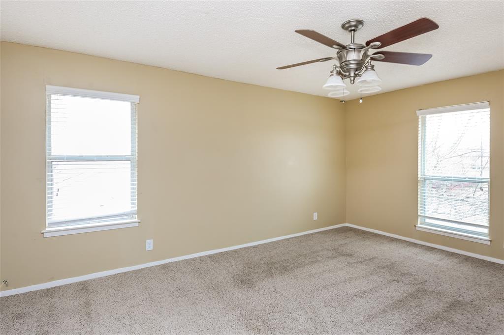 1130 Judy Avenue Benbrook, TX 76126 - Photo 10 of 17 a view of a big room with windows and chandelier fan