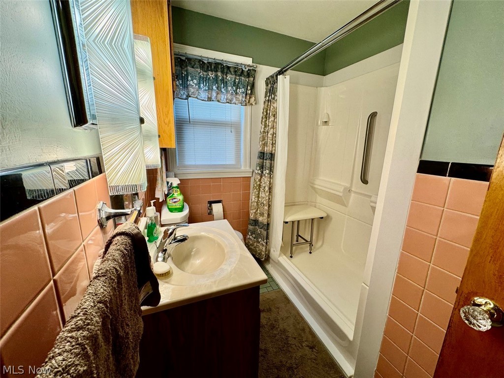 4426 2nd Street Northwest Canton, OH 44708 - Photo 17 of 20 Bathroom featuring vanity and tile walls