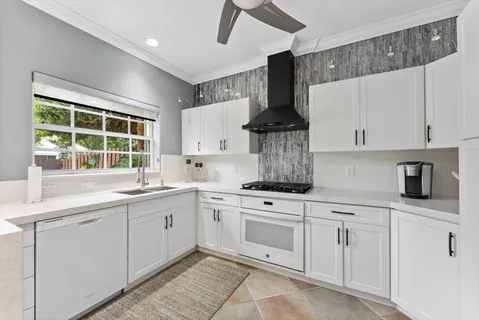 a kitchen with white cabinets and white appliances