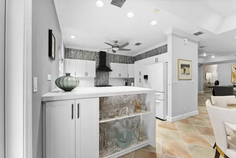 a kitchen with stainless steel appliances a table and chairs