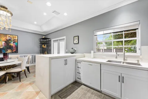a kitchen with sink attached with living room