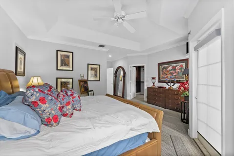 a spacious bedroom with a bed and a dresser