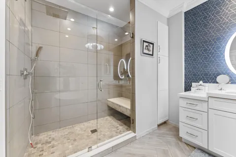 a bathroom with a granite countertop sink a toilet and shower