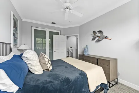 a bedroom with a bed and a chandelier