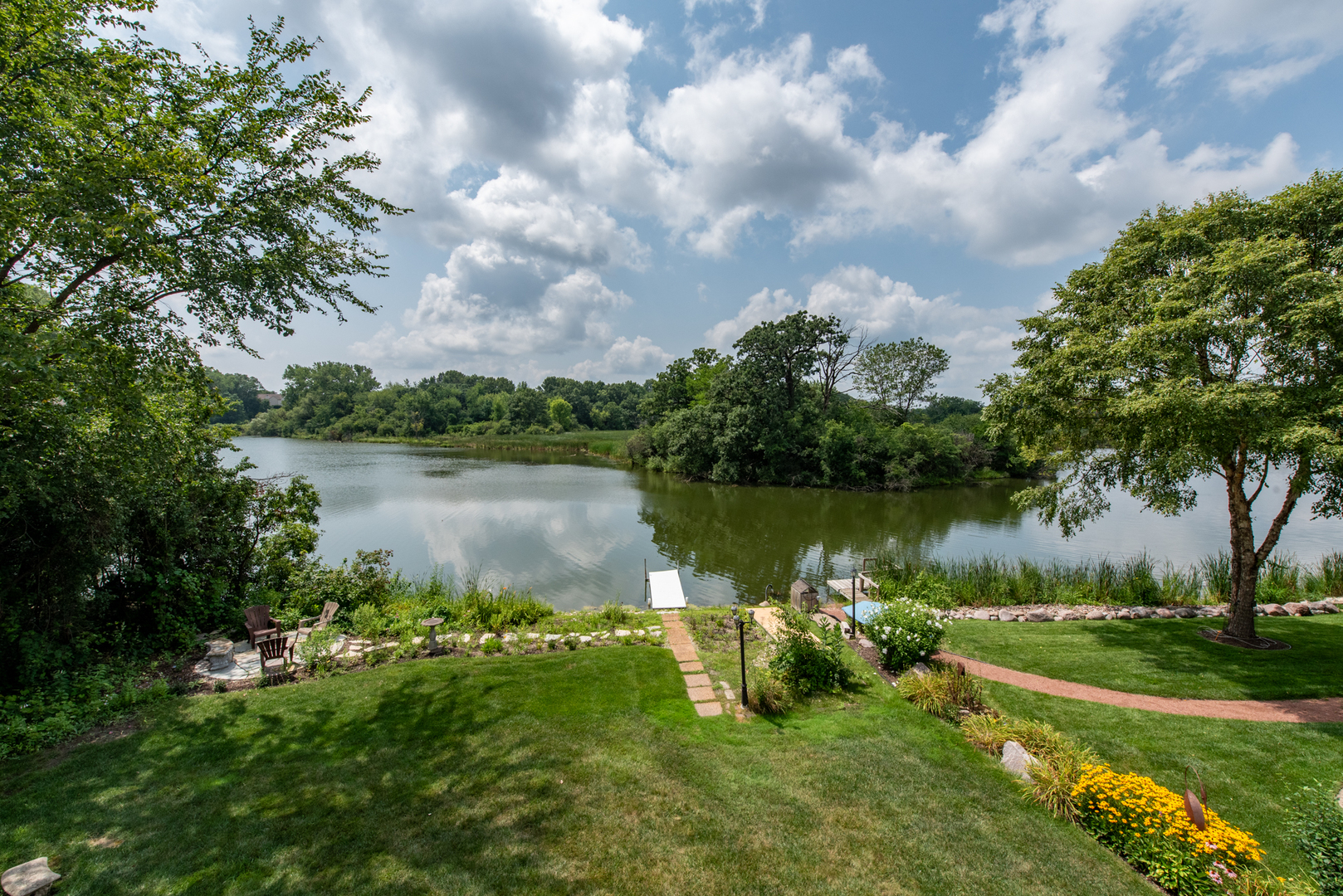 1146 Edgewater Lane Antioch, IL 60002 - Photo 3 of 23 a view of a lake with a big yard and potted plants and large trees