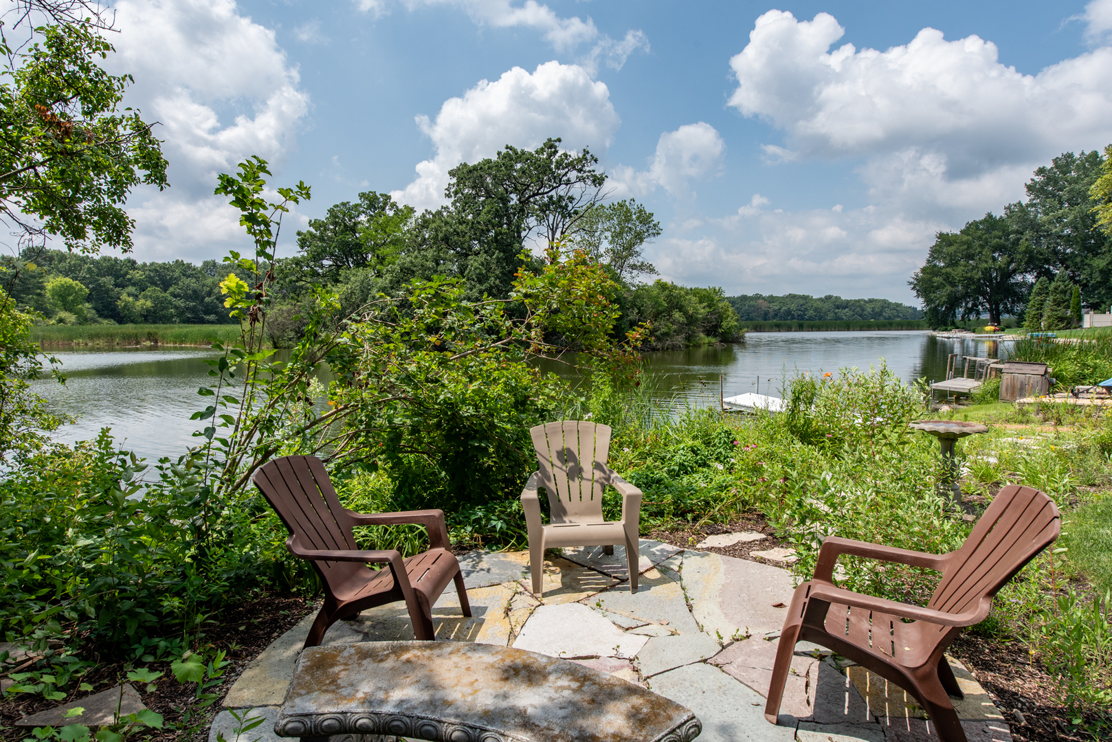 1146 Edgewater Lane Antioch, IL 60002 - Photo 7 of 23 a view of a lake with table and chairs and potted plants
