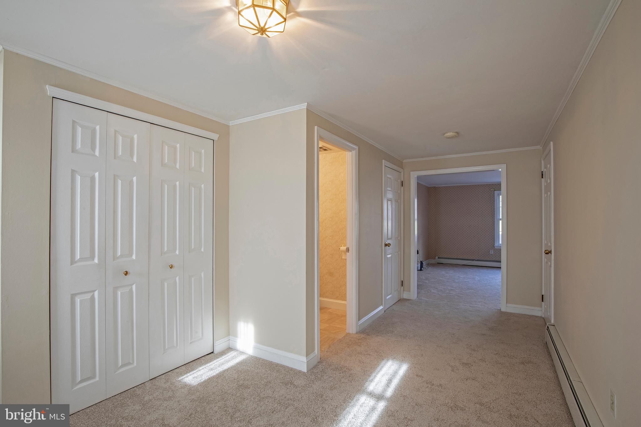 Foyer with closet space and half bath