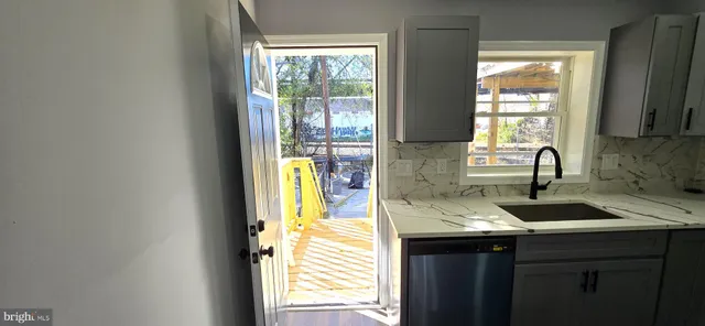 a bedroom with a bed and a flat tv screen on dresser
