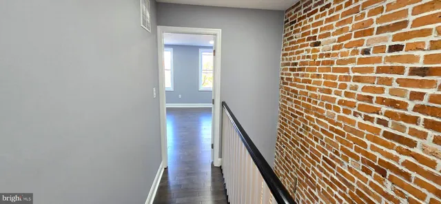 a view of an entryway with wooden floor