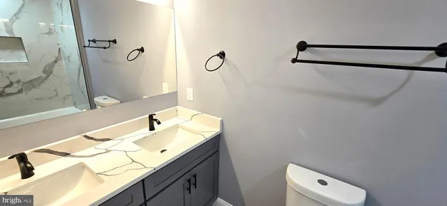 a view of a house with large windows and a table and chairs