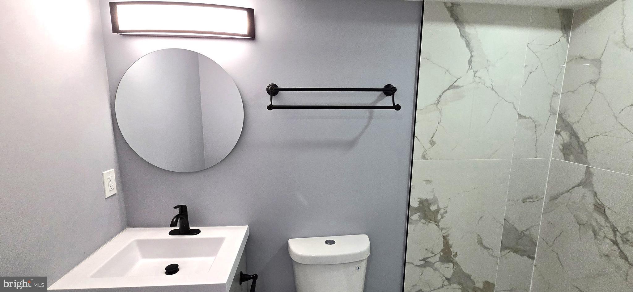 304 South Lehigh Street Baltimore, MD 21224 - Photo 35 of 47 a bathroom with a sink and a mirror