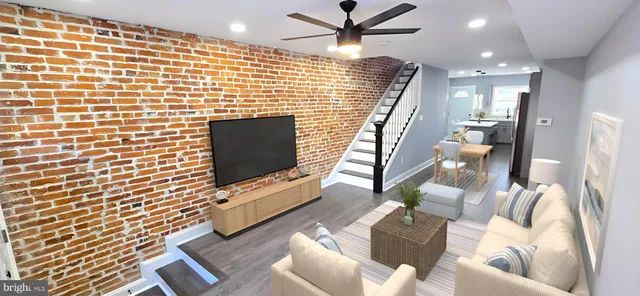 a kitchen with stainless steel appliances kitchen island granite countertop a refrigerator a sink a stove a dining table and chairs