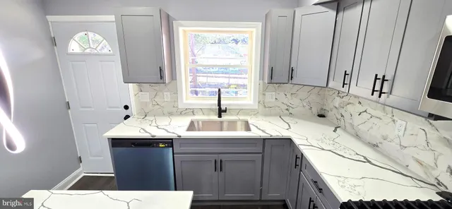 a kitchen with stainless steel appliances kitchen island sink refrigerator and stove