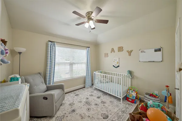 a spacious bathroom with a double vanity sink a toilet a mirror and shower