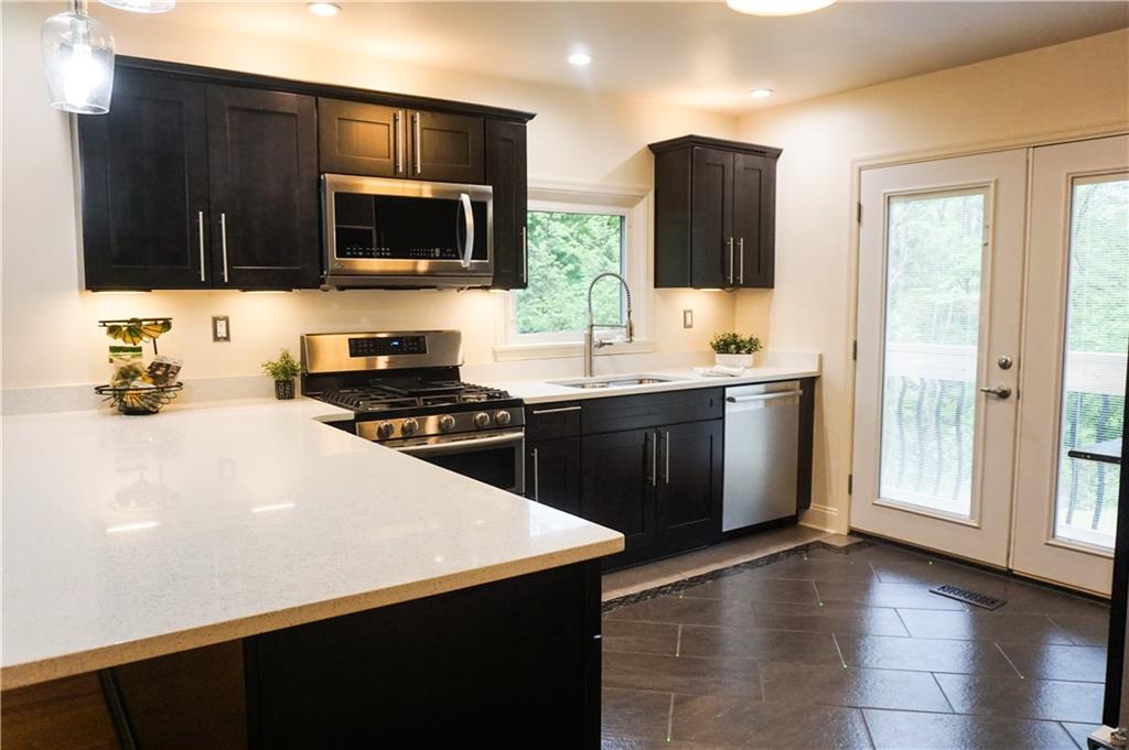 826 Belmont Road Butler, PA 16001 - Photo 8 of 20 QUARTZ COUNTER TOPS ADD TO THE CLEAN LINES OF THIS OPEN SPACE