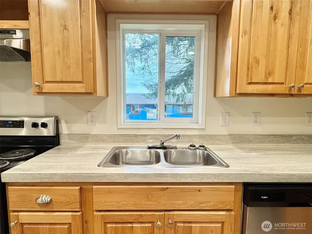 a kitchen with a sink and cabinets