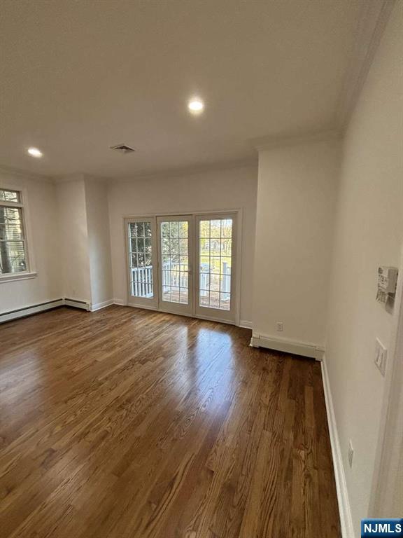 124 Coopers Lane River Vale, NJ 07675 - Photo 13 of 25 an empty room with wooden floor and windows