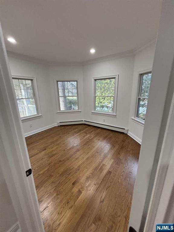 124 Coopers Lane River Vale, NJ 07675 - Photo 16 of 25 a view of an empty room with wooden floor and a window