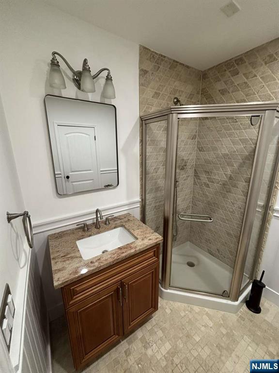 124 Coopers Lane River Vale, NJ 07675 - Photo 20 of 25 a bathroom with a sink a mirror and a shower