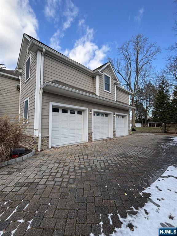 124 Coopers Lane River Vale, NJ 07675 - Photo 4 of 25 a front view of a house with a yard and garage