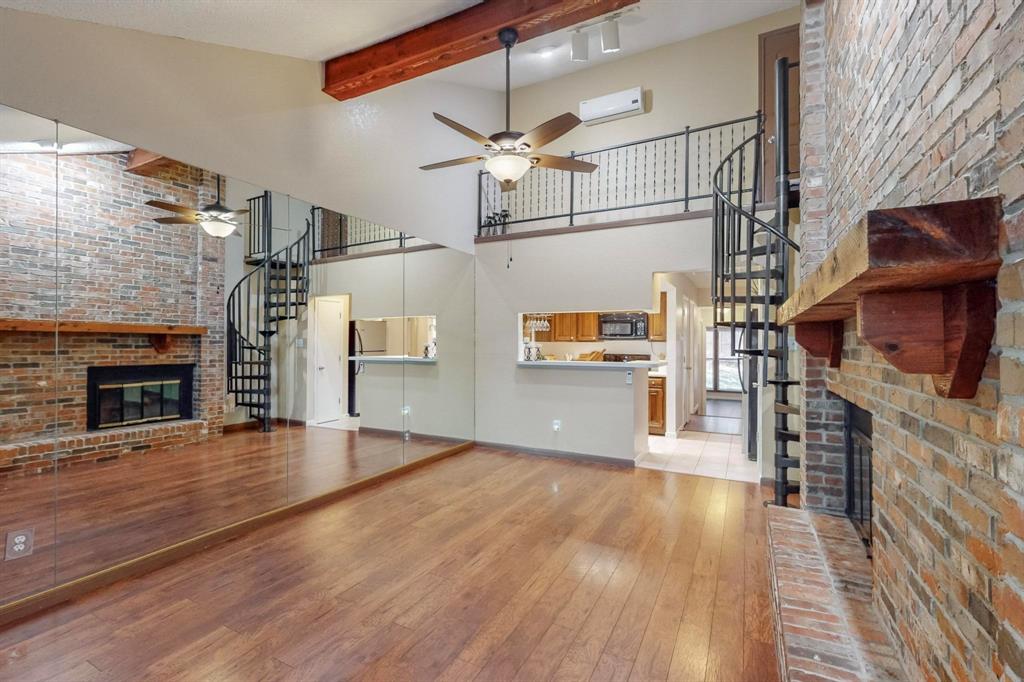 2569 Shady Ridge Drive Bedford, TX 76021 - Photo 11 of 38 an empty room with wooden floor fireplace and windows