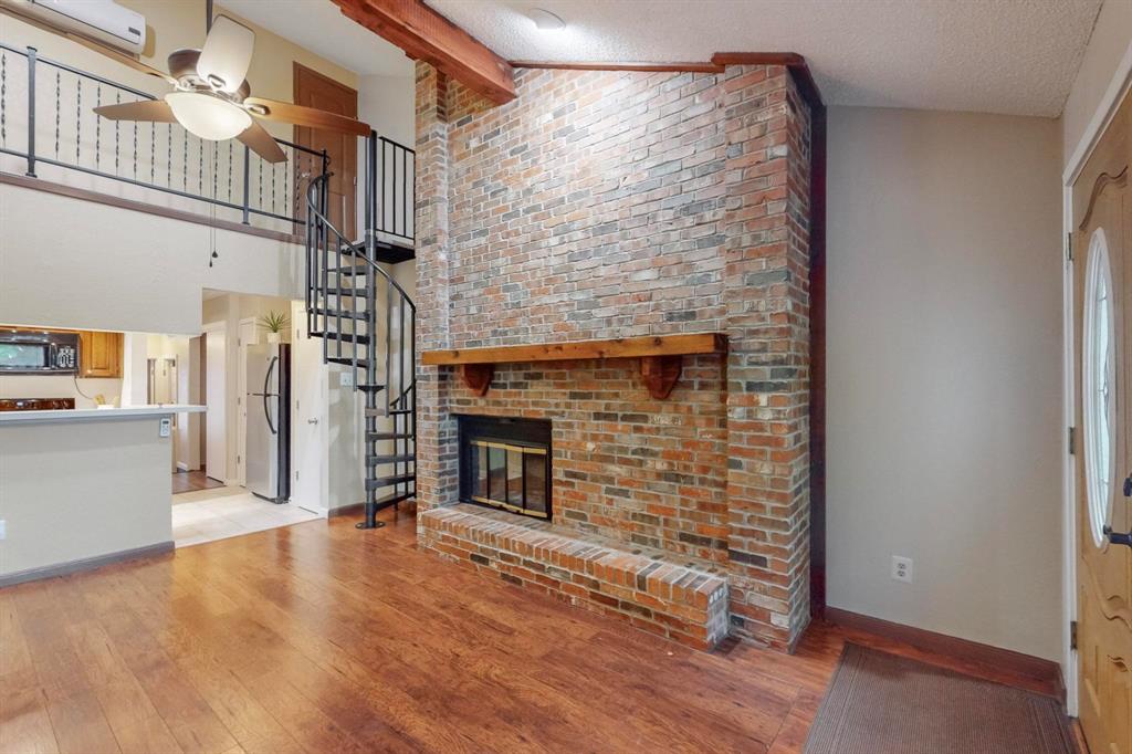 2569 Shady Ridge Drive Bedford, TX 76021 - Photo 13 of 38 a view of empty room with wooden floor and fireplace