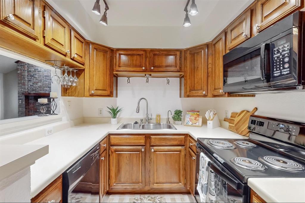 2569 Shady Ridge Drive Bedford, TX 76021 - Photo 16 of 38 a kitchen with stainless steel appliances granite countertop a stove a sink and a microwave