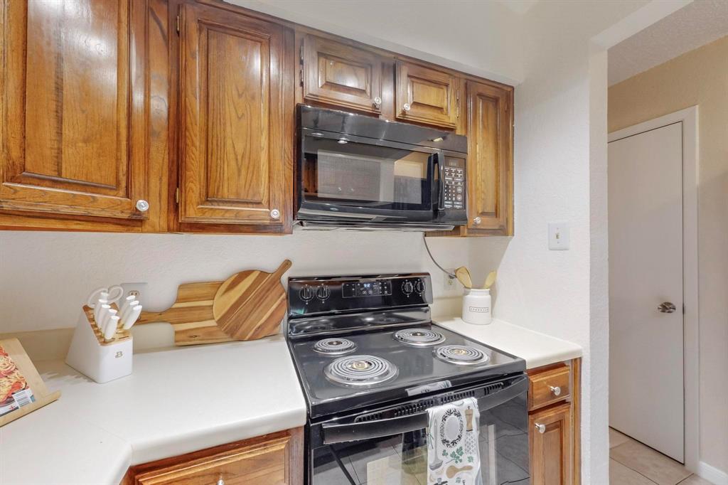 2569 Shady Ridge Drive Bedford, TX 76021 - Photo 18 of 38 a kitchen with a stove and a microwave