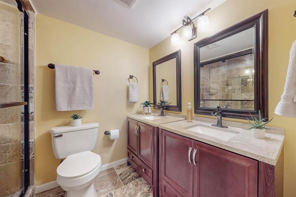 2569 Shady Ridge Drive Bedford, TX 76021 - Photo 21 of 38 a bathroom with a granite countertop toilet sink and mirror