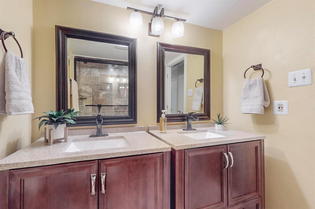 2569 Shady Ridge Drive Bedford, TX 76021 - Photo 22 of 38 a bathroom with a double vanity sink and a mirror
