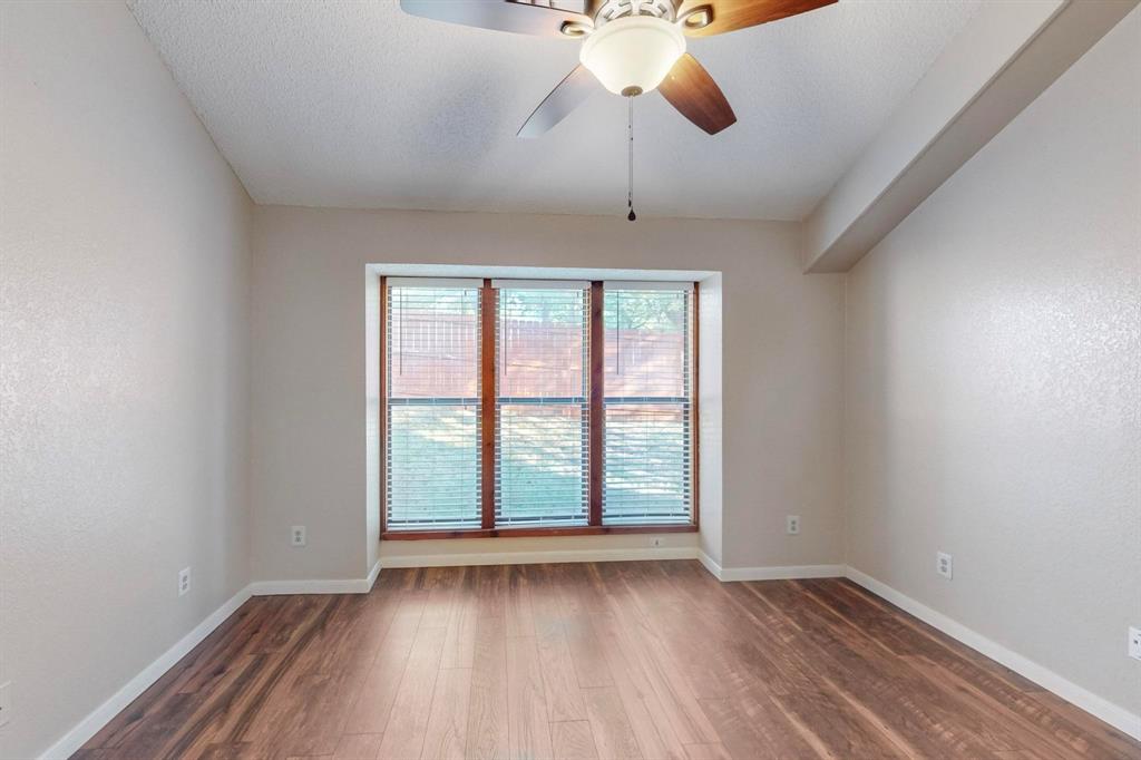 2569 Shady Ridge Drive Bedford, TX 76021 - Photo 26 of 38 wooden floor in an empty room with a window