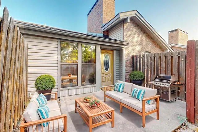 a view of a house with a wooden fence