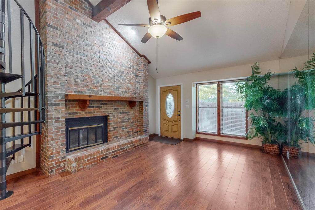 2569 Shady Ridge Drive Bedford, TX 76021 - Photo 8 of 38 a view of an empty room with wooden floor fireplace and a window