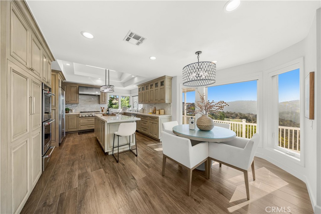 2640 Shady Ridge Lane Diamond Bar, CA 91765 - Photo 9 of 57 a kitchen with stainless steel appliances a dining table chairs stove and cabinets